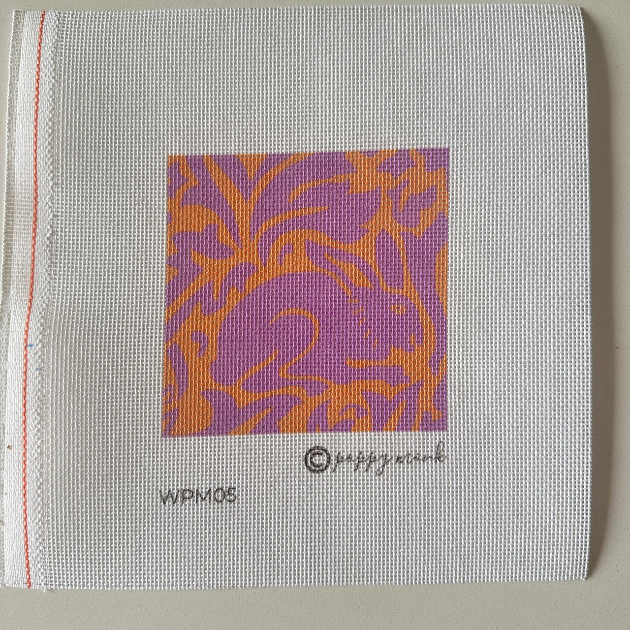rabbit needlepoint design in pink and orange