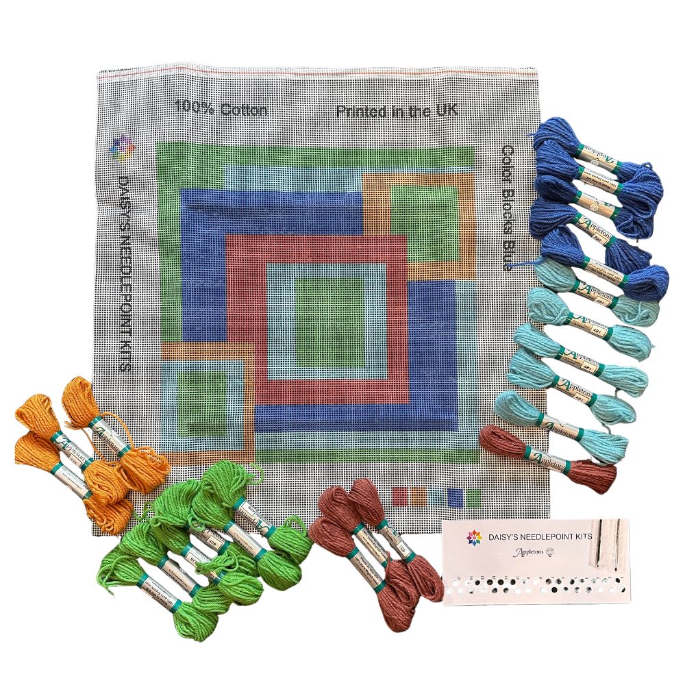 needlepoint pillow kit with abstract design and skeins of wool