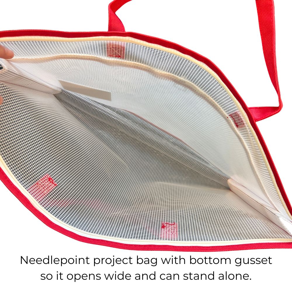 Open view of a red and white needlepoint project bag with a bottom gusset, showing the mesh interior and canvas edges, with text below explaining the feature.