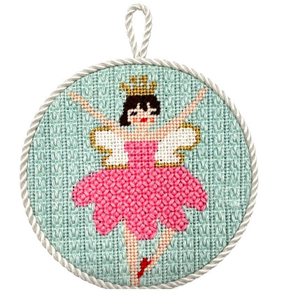 Needlepoint ballerina in a pink dress with a gold crown on a light blue background