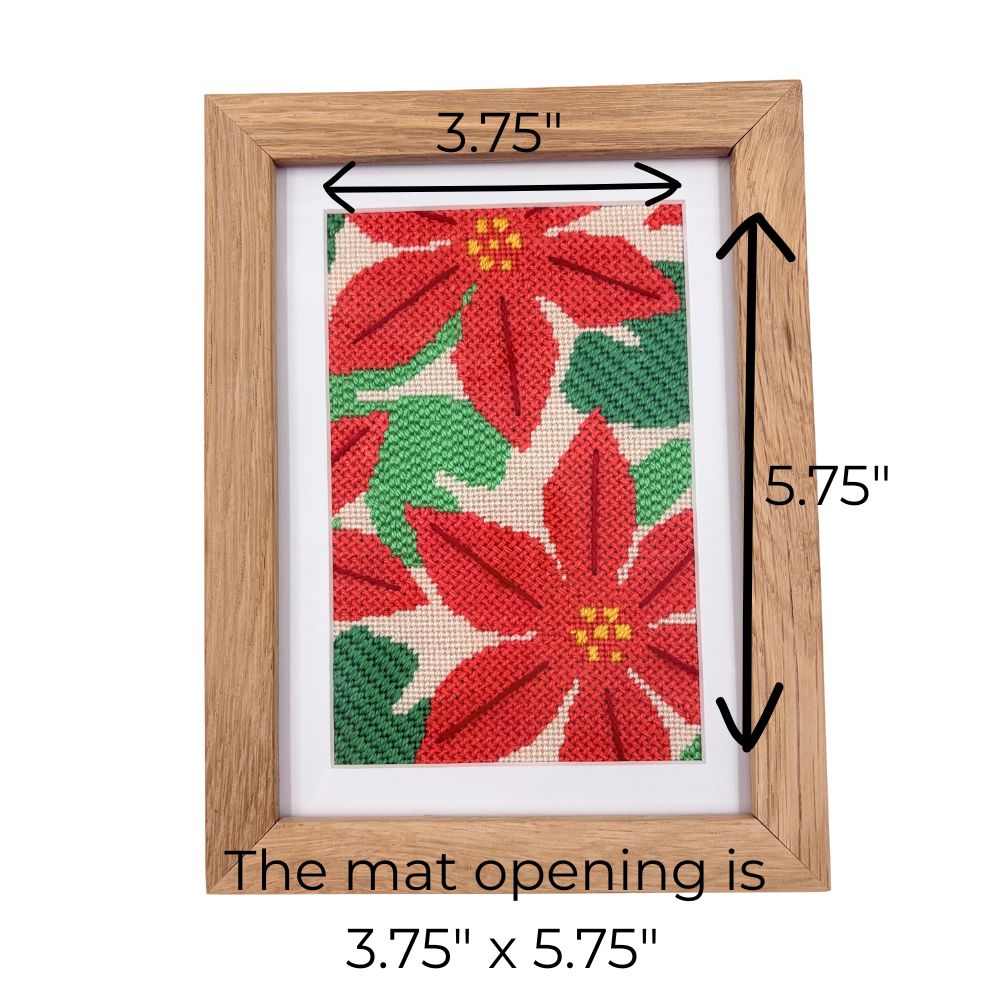 Wooden picture frame with poinsettia design and measurements on a white background