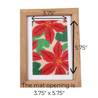 Wooden picture frame with poinsettia design and measurements on a white background