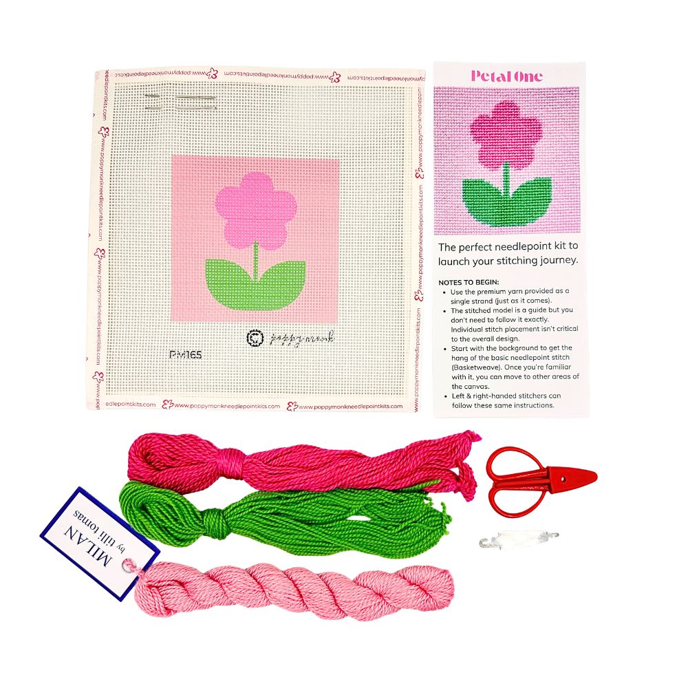 A needlepoint kit of a flower with threads and scissors