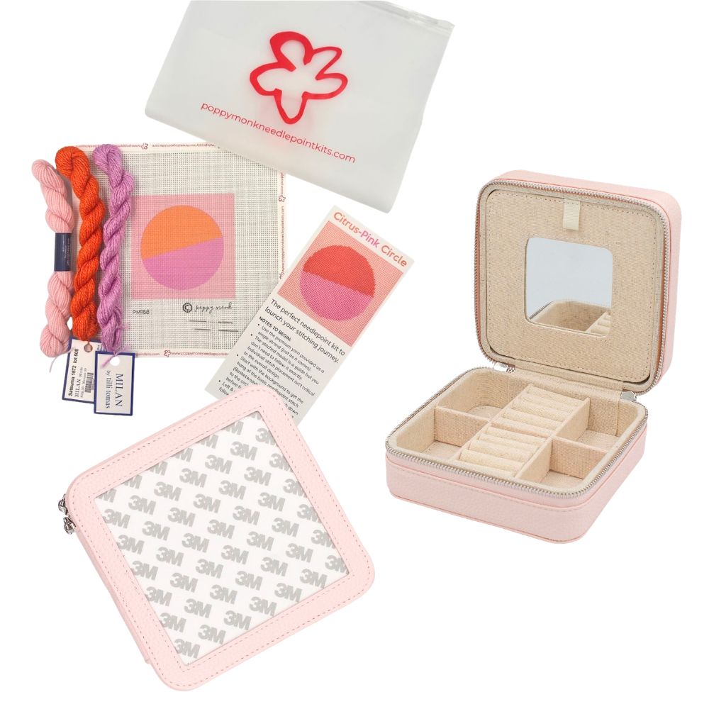 A pink jewelry box with a circle orange and pink needlepoint design