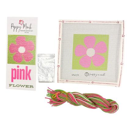 Pink Flower needlepoint kit with pink flower design, yarn, and packaging on a white background