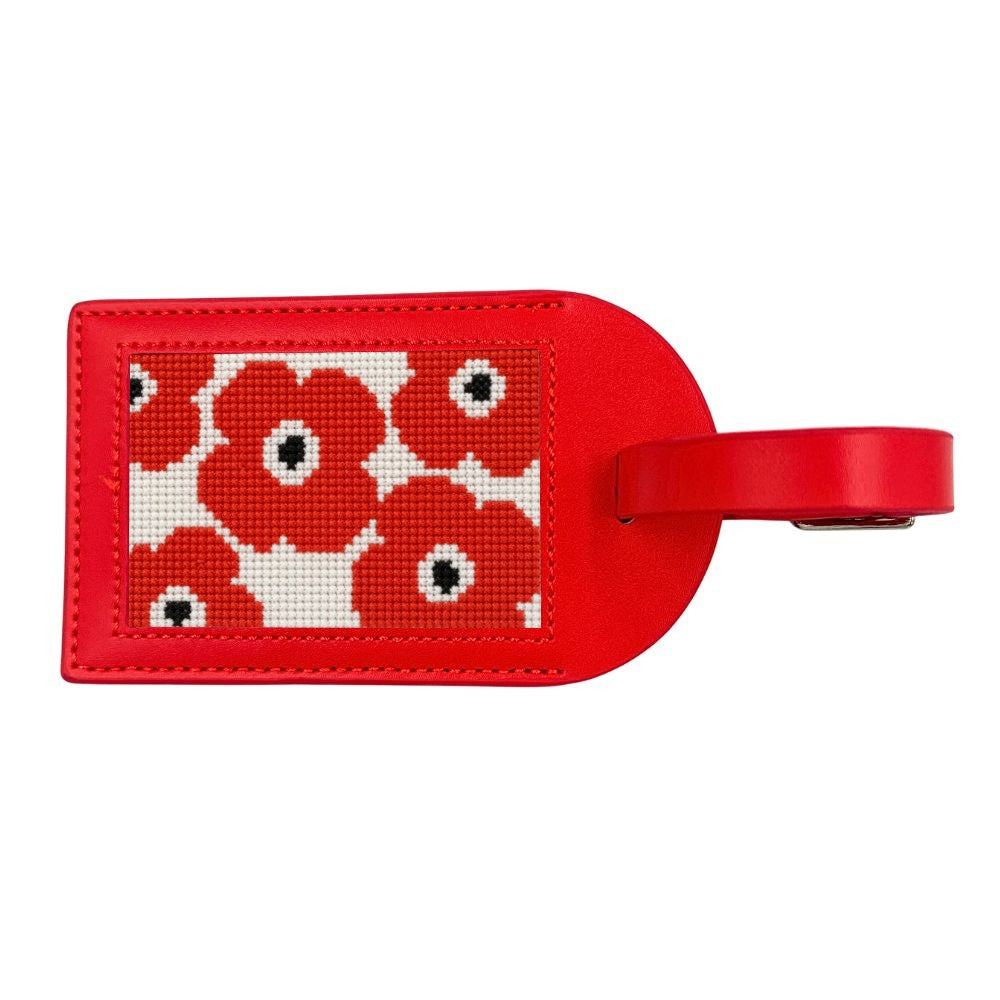 Red luggage tag with poppies