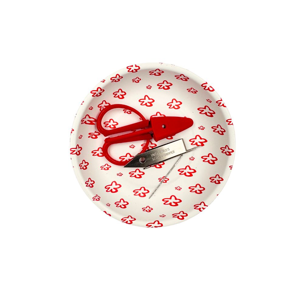 scissors and needles in a dish