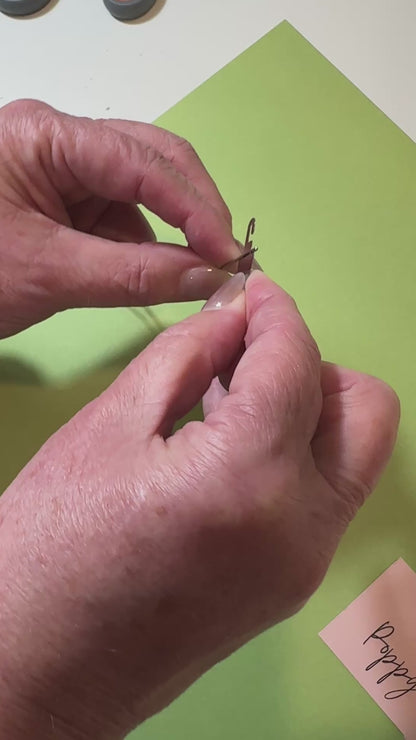 showing how to use a needle threader