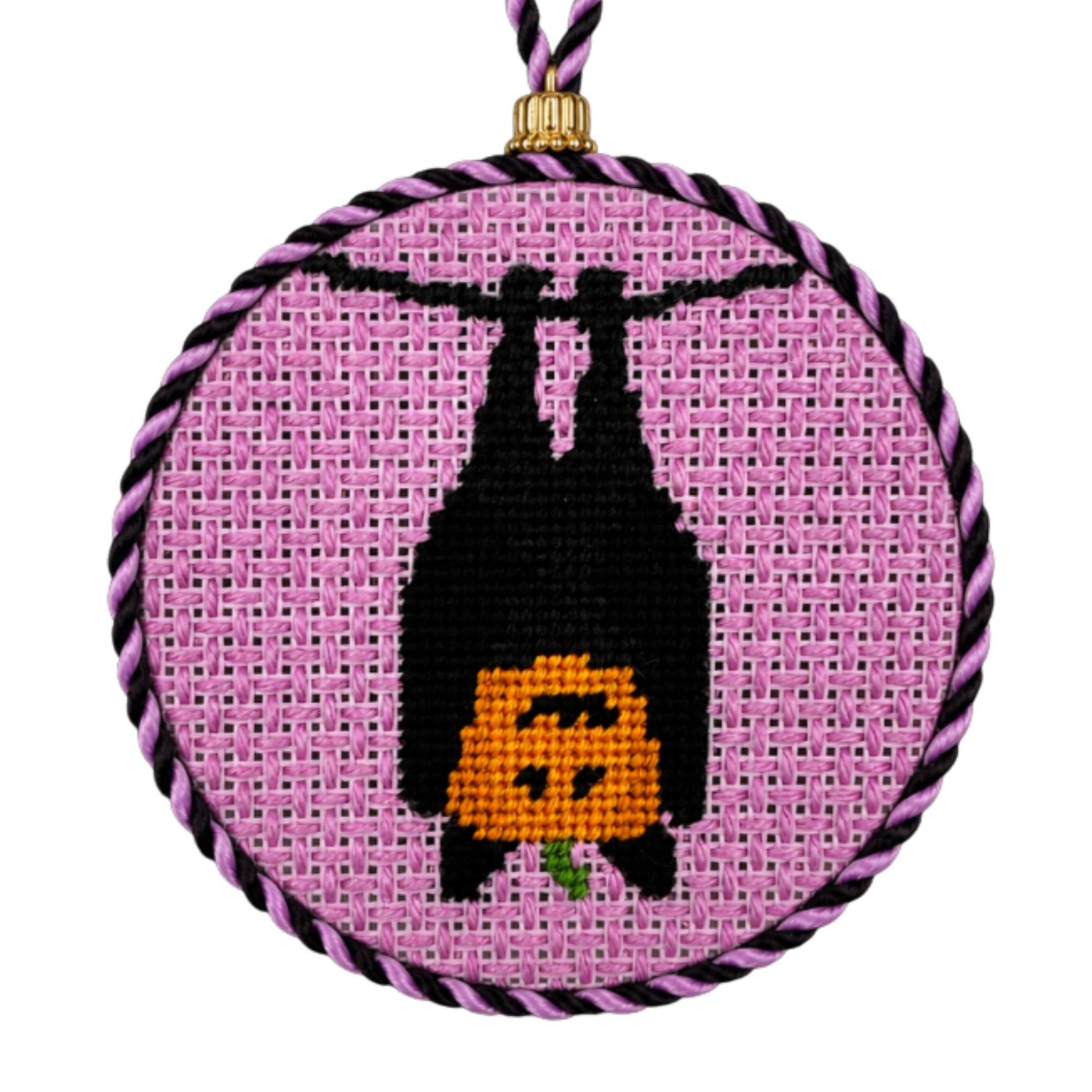 A Halloween needlepoint design of a pumpkin in a bat costume, finished as an ornament