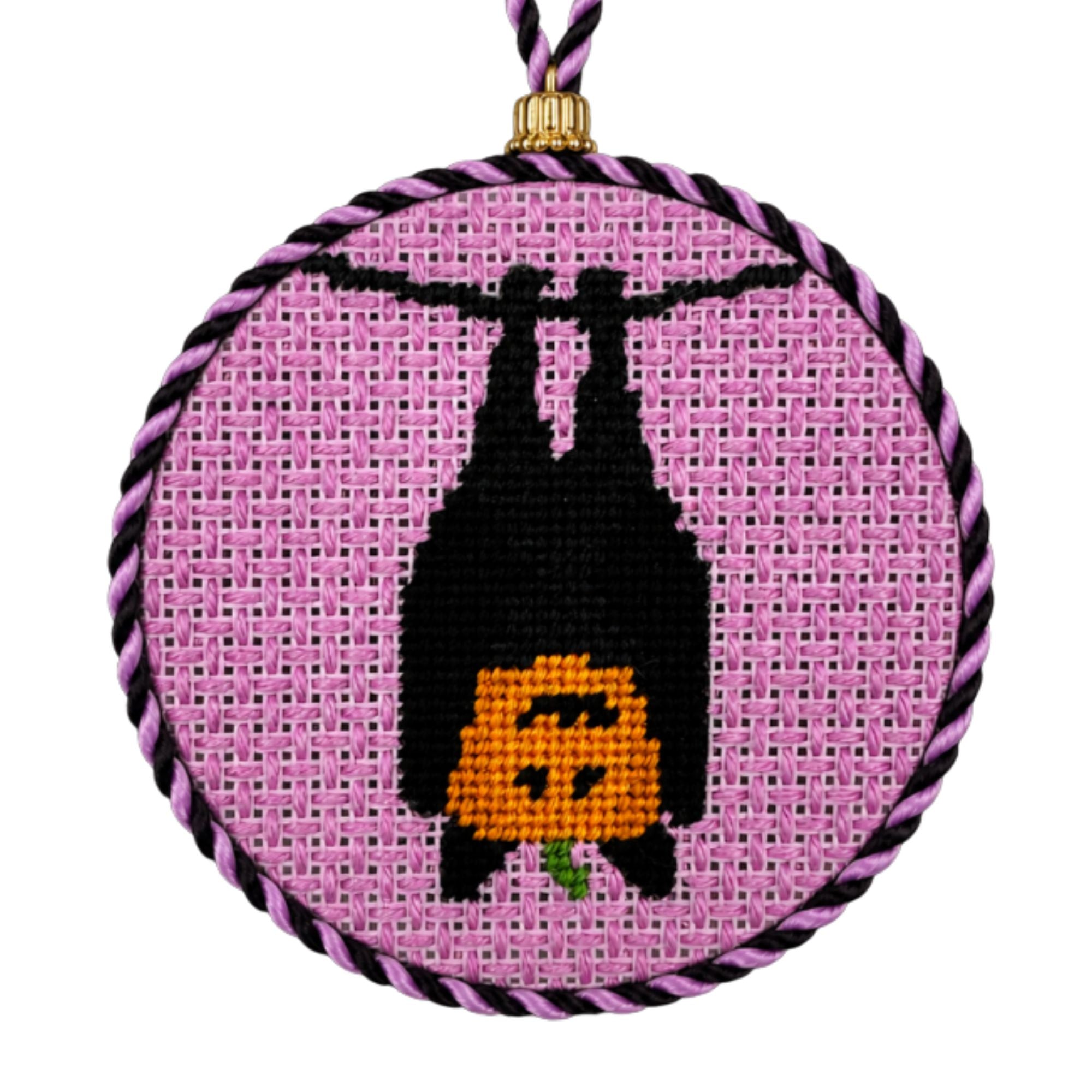 A Halloween needlepoint design of a pumpkin in a bat costume, finished as an ornament