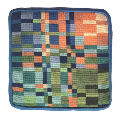 Square patchwork cushion with a geometric pattern on a white background