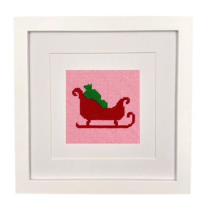A framed needlepoint design of Santa&