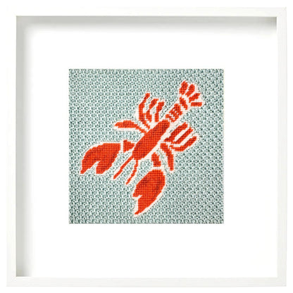 A framed needlepoint lobster design