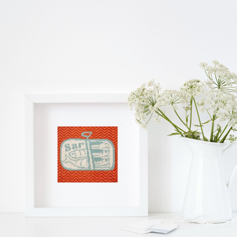a framed picture of a sardines needlepoint on a white background
