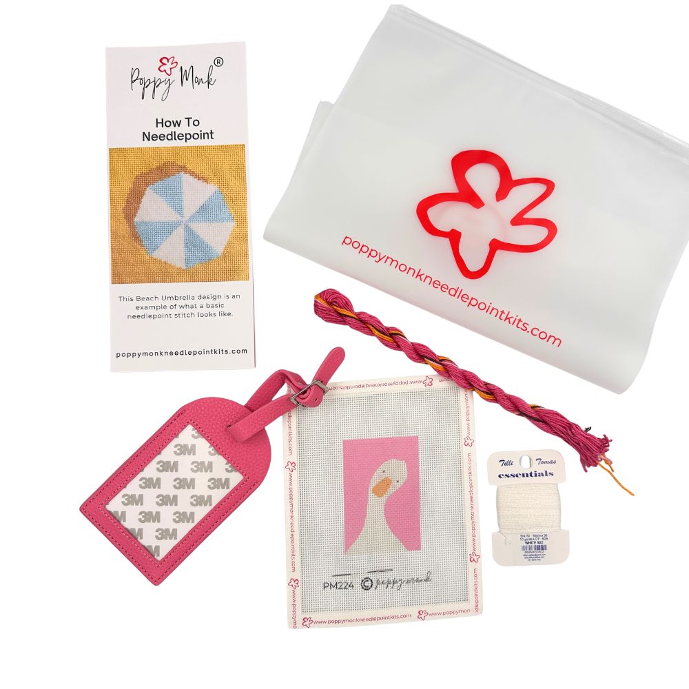 Needlepoint luggage tag kit with a goose picture, threads, instructions, a bag.