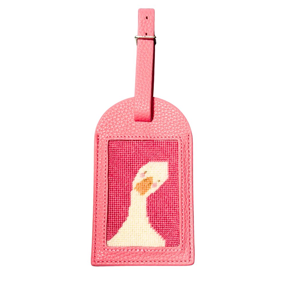 A pink luggage tag with a goose design