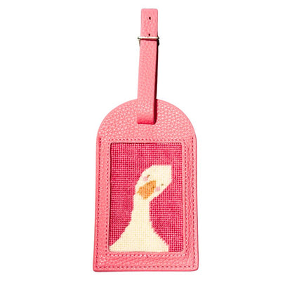 A pink luggage tag with a goose design