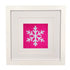 A square framed art piece featuring a white needlepoint snowflake on a bright pink fabric background, set within a white mat and a white wooden frame.