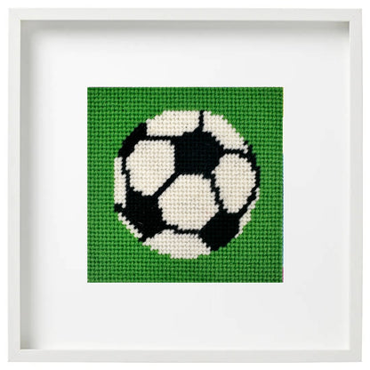 Needlepoint design os a soccer ball in a white frame