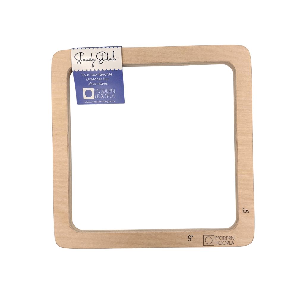 A square wooden needlepoint frame with rounded corners, featuring a blue and white &