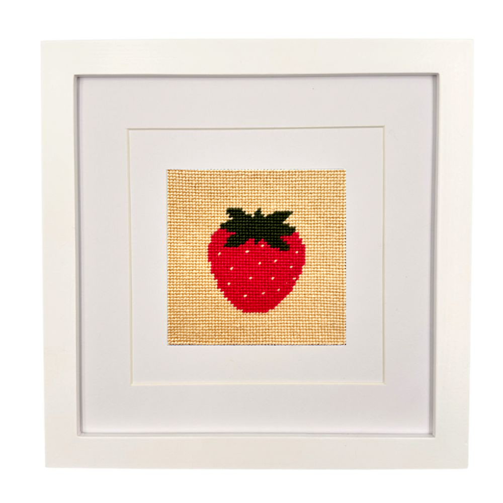 Framed needlepoint strawberry on a white background