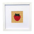 Framed needlepoint strawberry on a white background