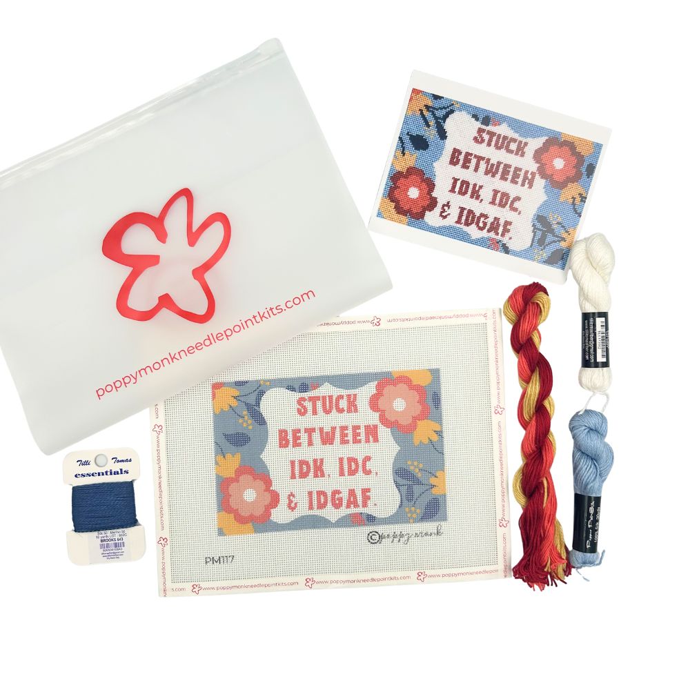 Poppy Munk needlepoint kit with yarn and accessories on a white background