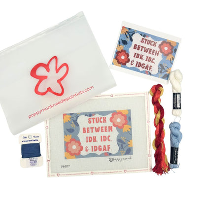 Poppy Munk needlepoint kit with yarn and accessories on a white background