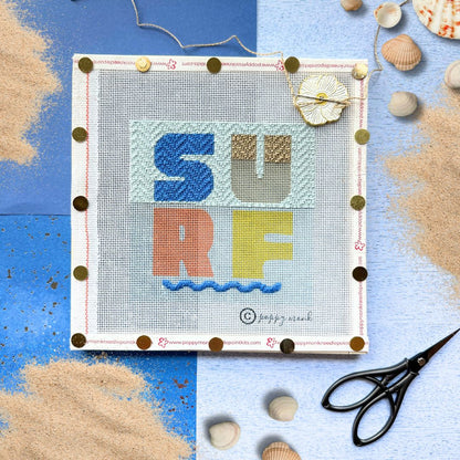 Surf Beach sign needlepoint kit held tight by needlepoint stretcher bars