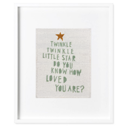 Needlepoint in a white frame with &