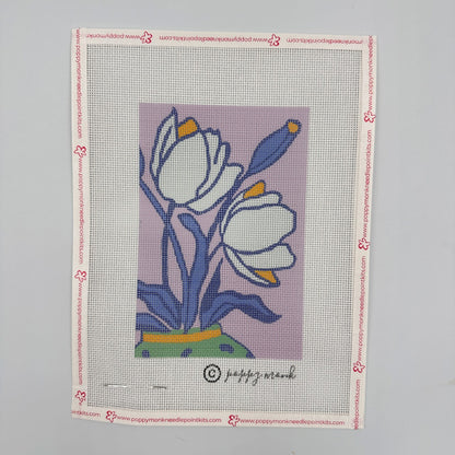 Needlepoint canvas with floral design on a gray background