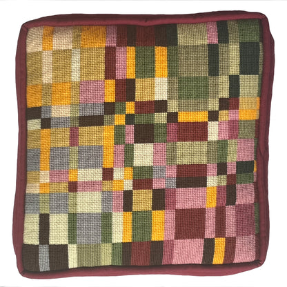 Square cushion with a multicolored checkered pattern on a white background
