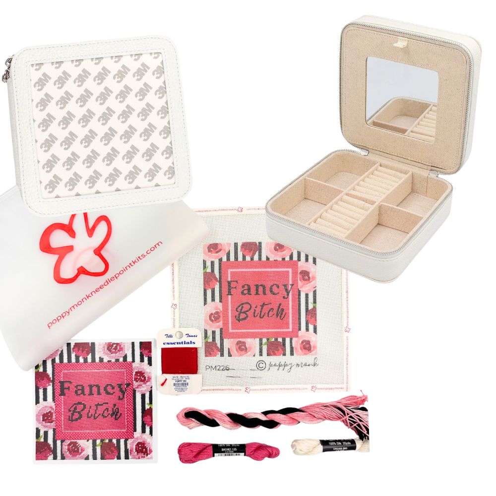 A craft kit featuring a white zippered pouch with a pink logo, a beige jewelry organizer box with a mirror, a printed fabric panel reading &