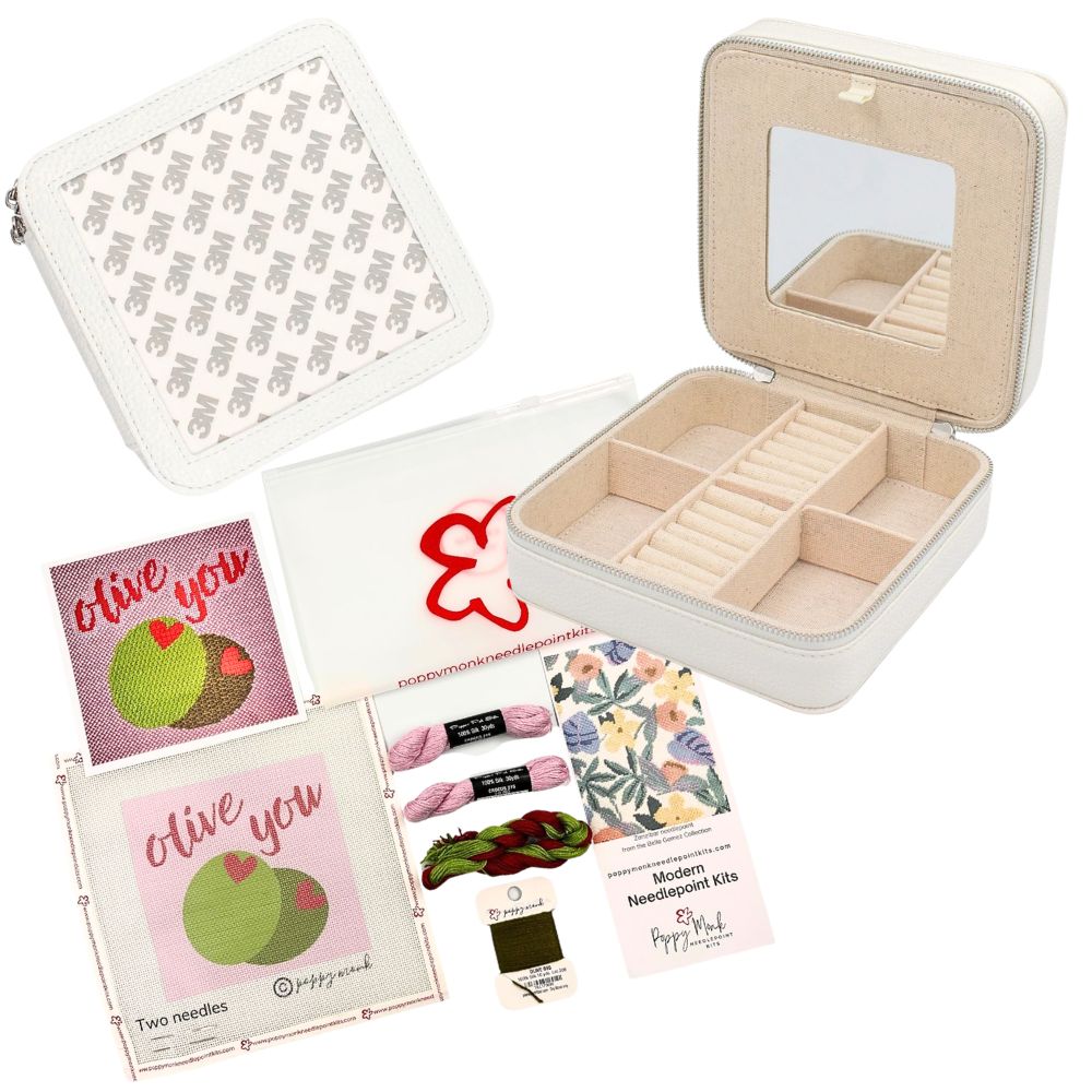 A curated gift set featuring a cream faux-leather jewelry organizer box with an interior mirror, accompanied by floral &