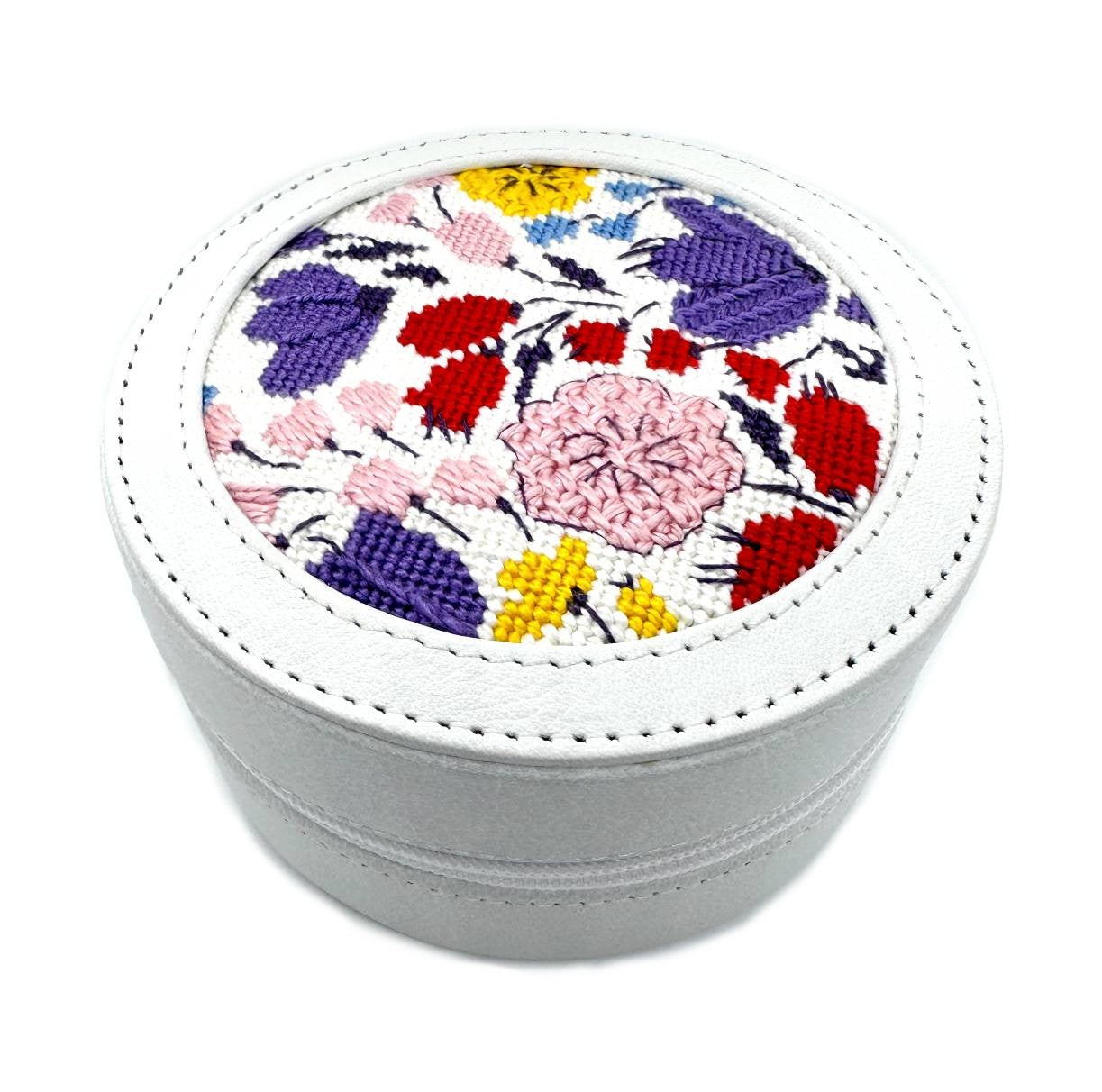 Round white leather box for needlepoint insert as a self-finishing project.