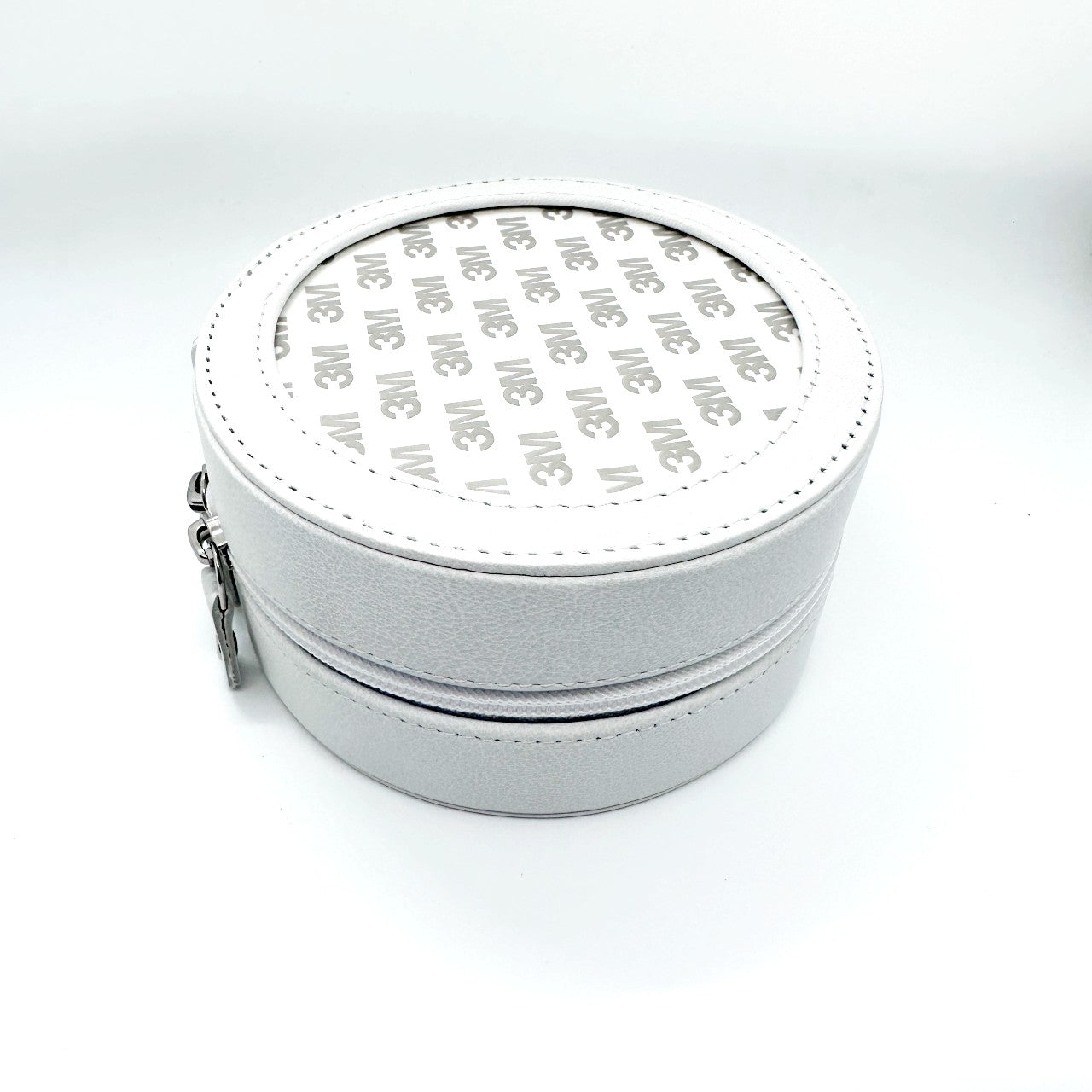 Round white leather box for needlepoint insert as a self-finishing project.