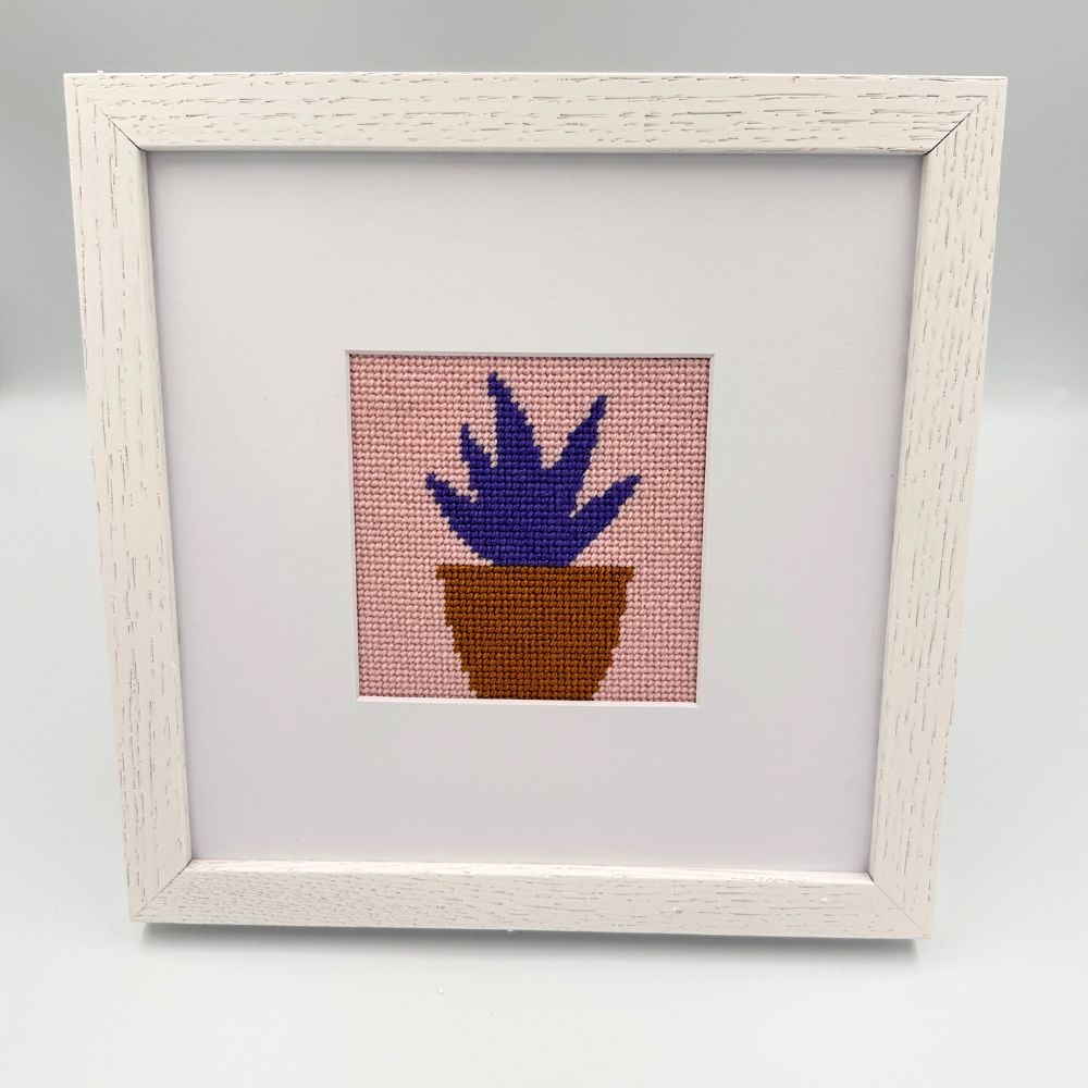 white oak frame with a needlepoint design