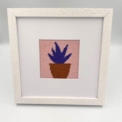 white oak frame with a needlepoint design