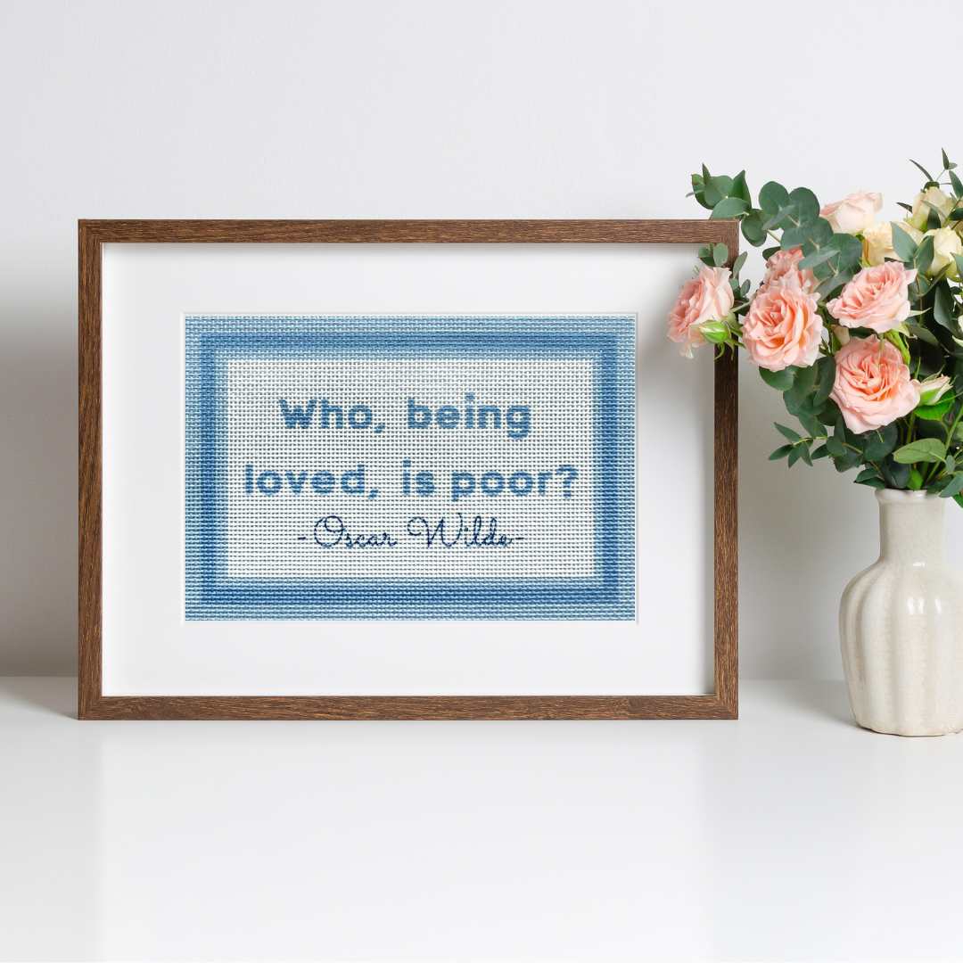 Needlepoint kit with an Oscar Wilde saying Who Being Loved Is Poor.