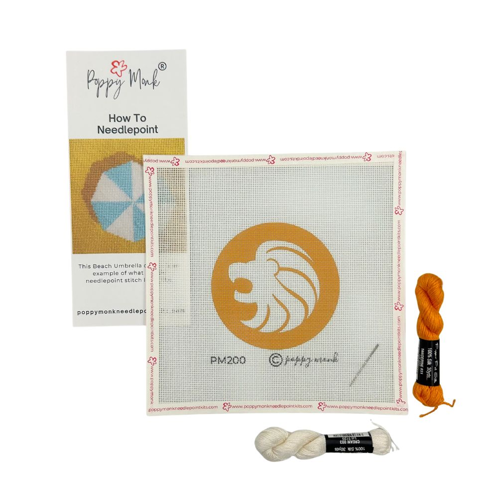 Leo lion eedlepoint kit with canvas, yarn, and instructions on a white background