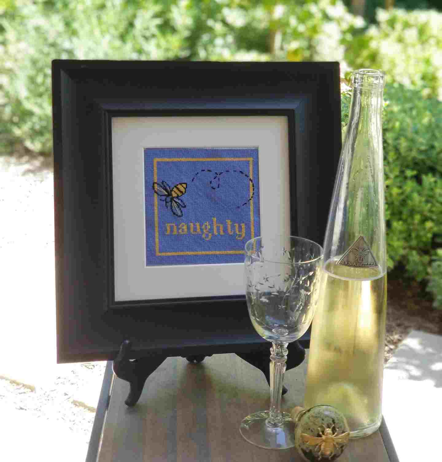 Bee Naughty small needlepoint kit with silk threads, shown framed.
